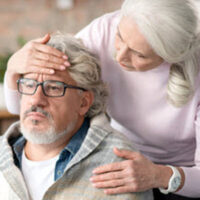 wife checking on elder husband on palliative care