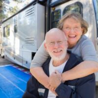older couple with their RV trailer