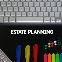 estate planning with keyboard on top and pens