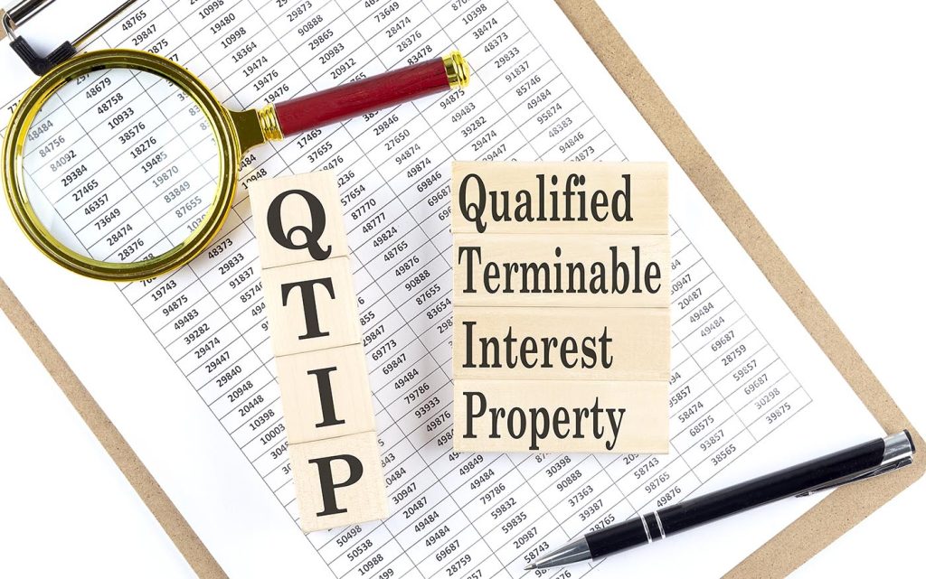 QTIP Qualified Terminable Interest Property Trust text on wooden block on chart background